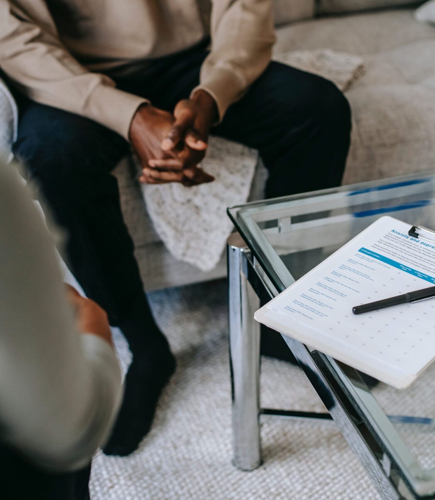Man with anxiety in Counselling Session, sitting on Couch, with a Counsellor.
