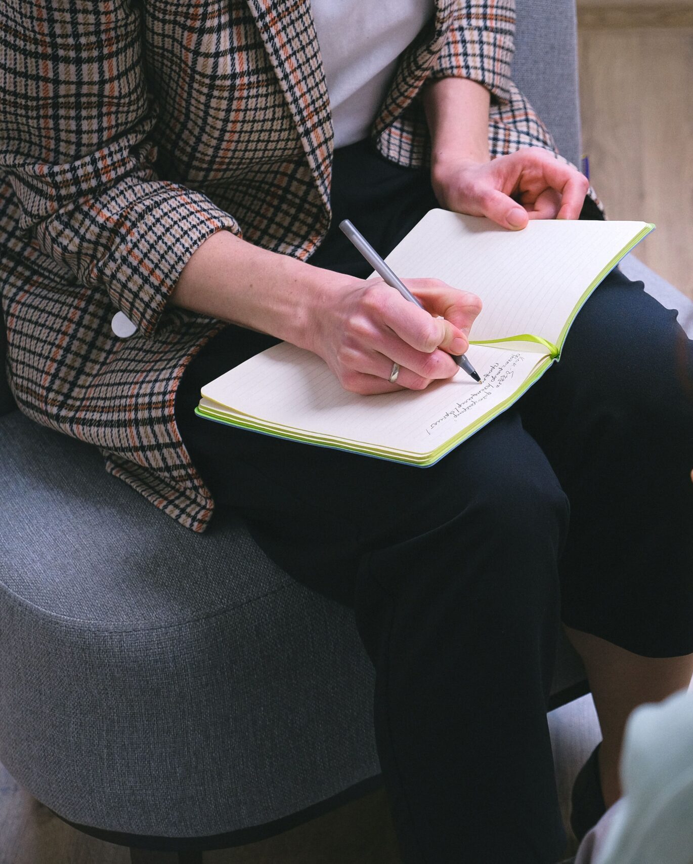 Professional counsellor taking notes during an individual counselling session